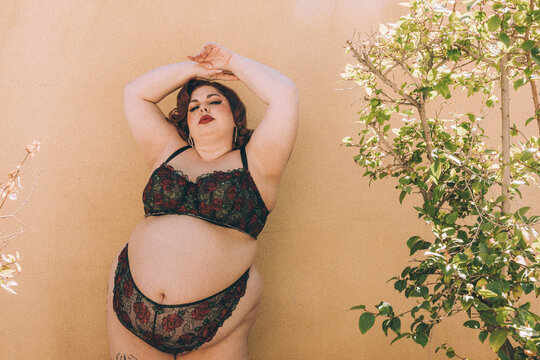 Plus size old Hollywood lingerie model outdoors