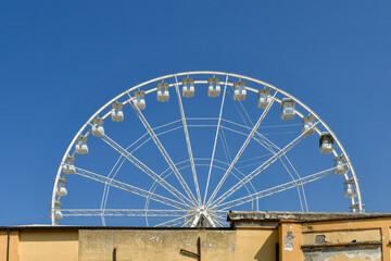 Top half of a ferris wheel against blue sky