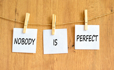 Nobody is perfect symbol. Concept words Nobody is perfect on beautiful white paper on clothespin....
