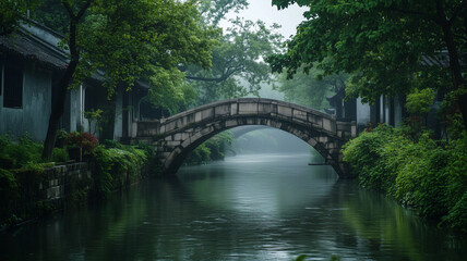Fototapeta premium Tranquil River Flowing Beneath an Ancient Stone Bridge in a Peaceful Village with Lush Greenery (2)