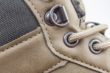 Close-up shot of a sturdy hiking boot with suede and leathersynthetic fabric, metal buckles for...