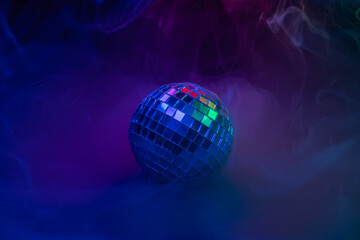 A vibrant, dynamic image showcasing a disco ball with colorful bokeh effects, conveying energy, party atmosphere, celebration, and fun