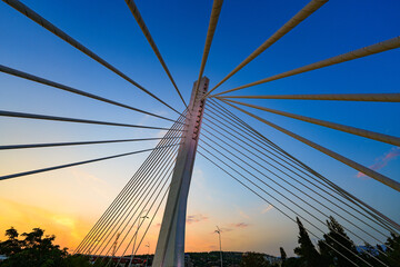 Fototapeta premium Millenium Bridge (Most Milenijum), a cable-stayed bridge that spans the Moraca river in Podgorica, the capital city of Montenegro in the Balkans