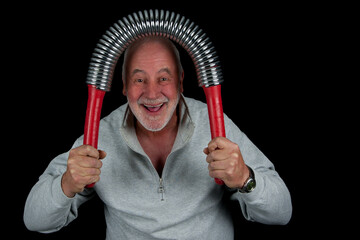 A 68-year-old senior, full of life, laughing as he bends a heavy King’s Feather above his head – the perfect balance of strength, humor, and zest for life.