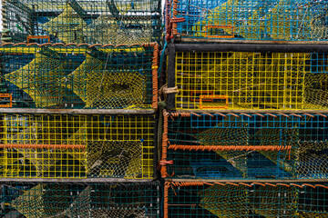 Photograph of stacked colorful ready crab traps sitting on fishing dock in Peggys Cove Nova Scotia...
