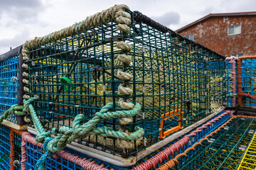 Close up photo of lobster crab pots stacked on dock in Peggy's Cove Nova Scotia, Canada