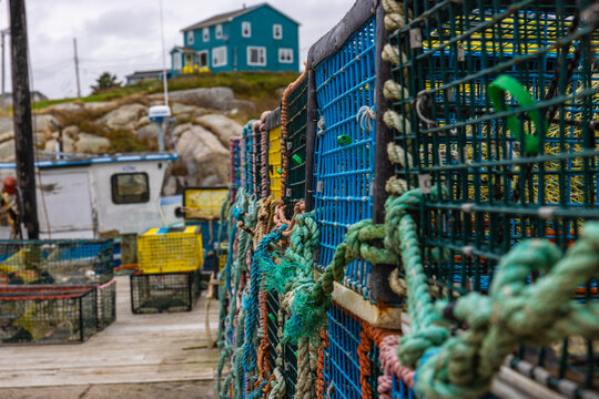Colorful crab cages stacked and noted fishing rope located in Peggys cove harbor in Nova Scotia Canada 
