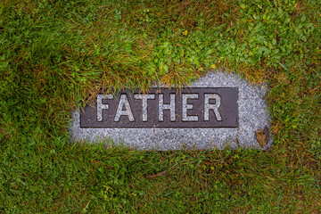 Grave marker in ground with the word father on it located at fairview lawn cemetery in Halifax, Nova Scotia, Canada