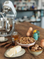 Ingredients for homemade butter are artfully arranged on a rustic wooden table, ready for a baking adventure in a charming kitchen filled with delightful aromas and inspiration