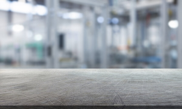 abstract blurred background and empty steel tabletop in foreground. Business presentation