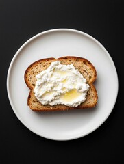 Photograph of a slice of bread on a white plate. the bread appears to be toasted and has a golden brown crust.