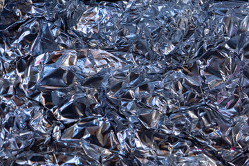 abstract background, futuristic crumpled metallic aluminum foil silvr, light blue, dark grey and...