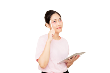 A woman in a pink shirt thoughtfully holds a tablet while pondering.