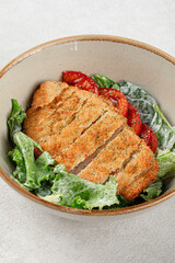 Portion of chicken schnitzel with fresh vegetables