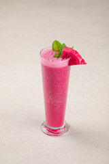 Glass of fresh dragon fruit pitahaya smoothie with mint