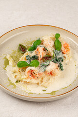 Portion of gourmet fettuccine with shrimps in cream sauce