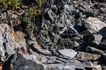 Photograph background texture of gray and brown slat stone sharp edges jagged rock