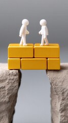 Two Figurines Standing on Blocks Over a Gap Representing Connection