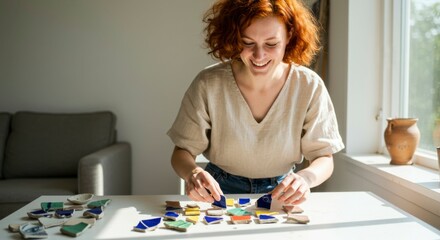 Fototapeta premium Woman arranging colorful mosaic tiles
