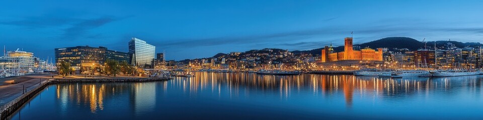 Fototapeta premium Glistening Oslo Panorama: Nighttime Skyline Overlooking City Hall and Harbor in Oslo, Norway
