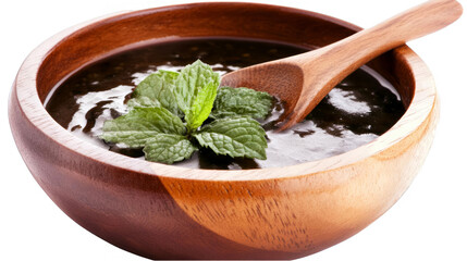 Isolated Wooden Bowl with Delicious Dark Soup Mint Leaves and Wooden Spoon