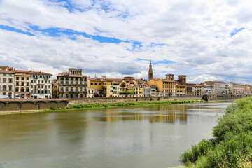 Fototapeta premium A river runs through a city Florence with a bridge over it