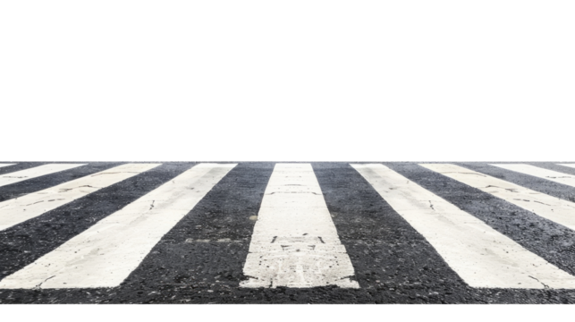 Crosswalk on a city street showing worn black and white lines leading to an empty area