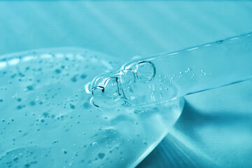 Serum in a pipette on a blue ribbed background.