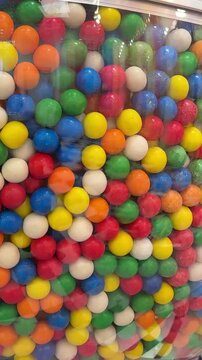 Colorful gumballs in classic vending machine, Multi colored buble gums, coin operated retro dispenser. Chewing gum candies as symbol of childhood and summertime. Mixed sweets in vintage automate.