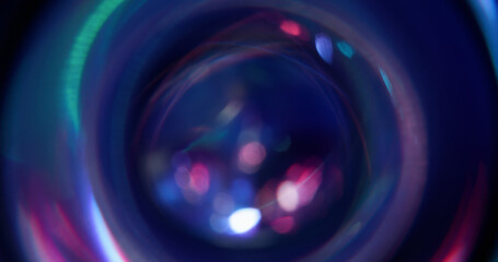 Flare glare. Blur light texture. Defocused purple pink green color lens sparkle on abstract abstract art bokeh dark black background.
