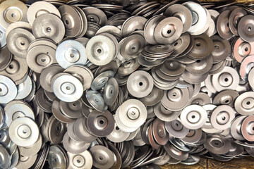 Closeup of assorted metal discs arranged in a container for industrial use