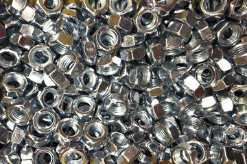 Closeup view of assorted metal nuts in a workshop setting