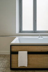 Modern bathtub setup in a stylish bathroom with natural light and minimal decor