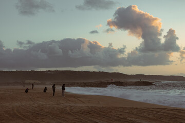 people watching the sunset of nazare