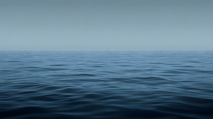 Obraz premium A vast, hazy ocean vista under a muted sky.