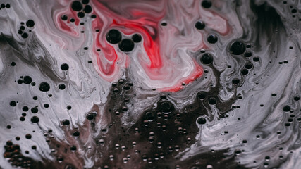 Sparkling flow. Oil liquid texture. Defocused white red color paint in water round shiny ink drop floating on abstract art acrylic background.