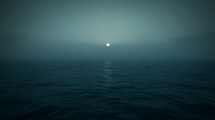Obraz premium Foggy ocean view with sun shining through mist creating a serene atmosphere.