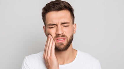 Closeup of person with toothache, holding jaw, Tooth pain