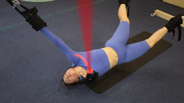 Suspended posture with anchored limbs and spiral breath woman expands through multi-angle stretch building inner tension to activate fascia and nervous system reset