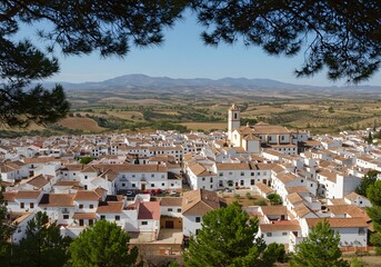 Obraz premium Panoramic View of a Whitewashed Andalusian Village Nestled Amongst Rolling Hills