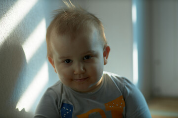 Toddler boy posing in home