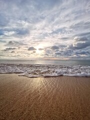Serene Beach Scene with Waves and Clouds