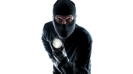 Masked figure with flashlight in dark setting during night hours