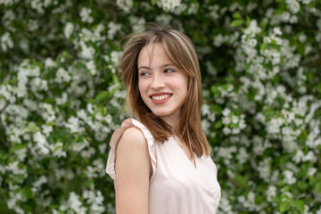 Young beautiful girl posing in a blooming garden