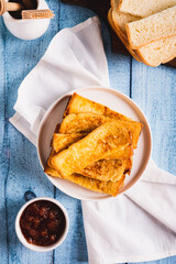 Traditional fried french toasts on white plate on table top and vertical view