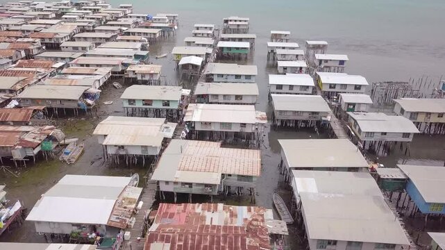 Aerial drone shot of Hanuabada village in Capital City Port Moresby, Papua New Guinea. Koki Stilt village. Motu tribe. Plenty of garbage everywhere. High quality 4k footage