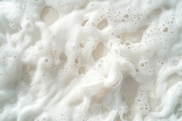 Foamy Wave Interacts With Black Oil Spill Trails on the Beach During a Warm Afternoon
