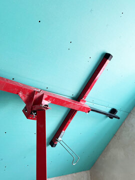 Drywall lift supports ceiling installation in a residential construction project