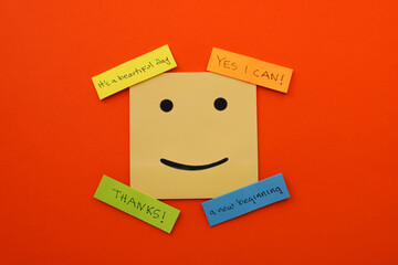 Happy face surrounded by colorful notes with personal development phrases
