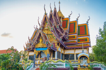 Thai Buddhist Wat Plai Laem temple with intricate golden roof details and dragon statues on Koh...